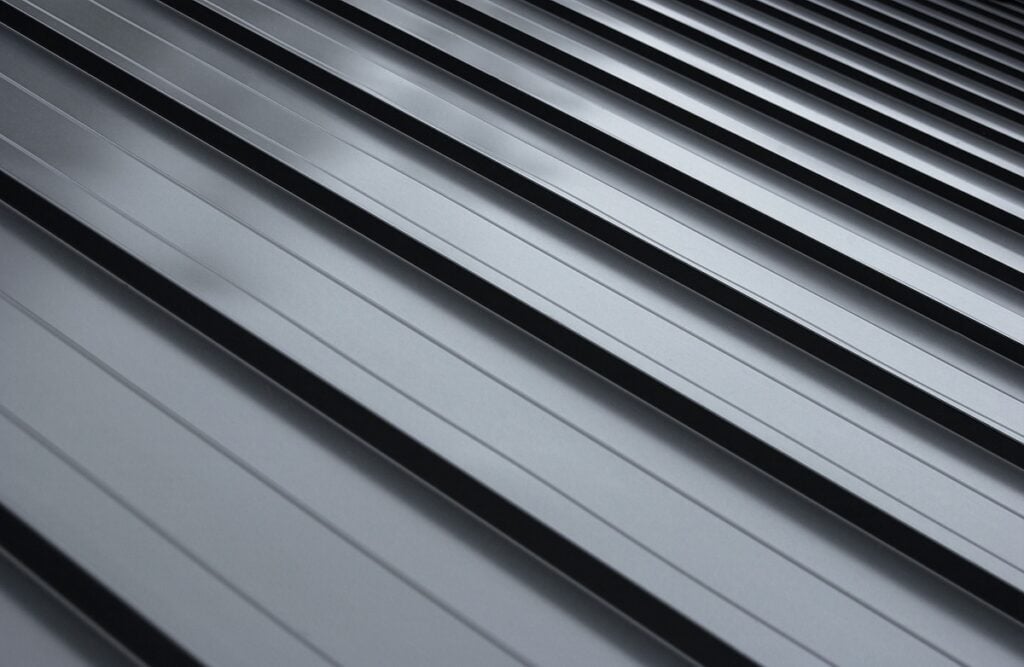 Close-up house roof panel with standing seam and fasteners.