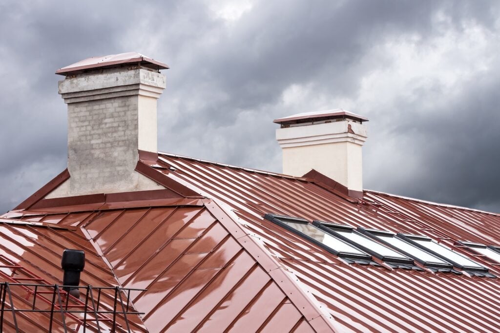 new red metal roof with skylights and chimneys