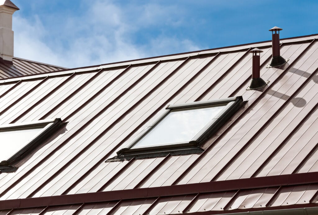 new metal roof with skylights against blue sky