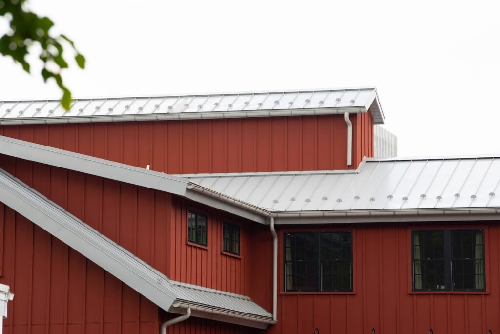 red siding metal seam roof