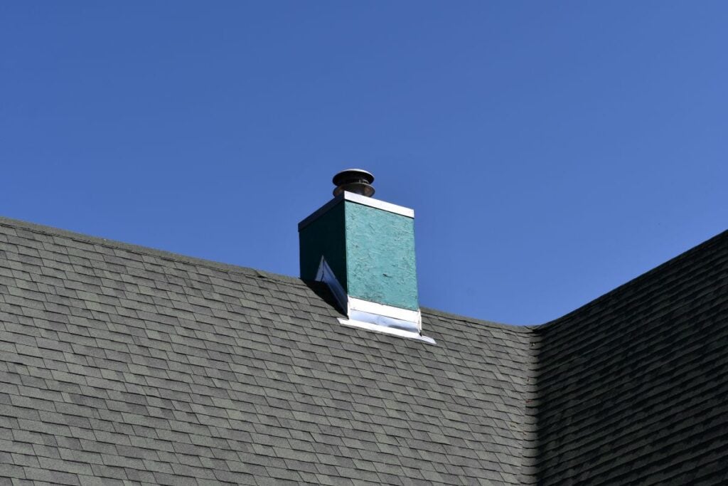 3 tab vs architectural shingles green roof chimney