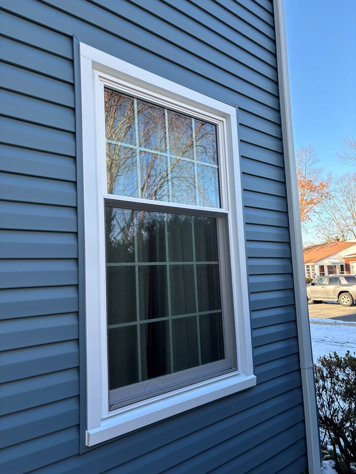 retrofit windows CTA Exteriors project blue siding white frame