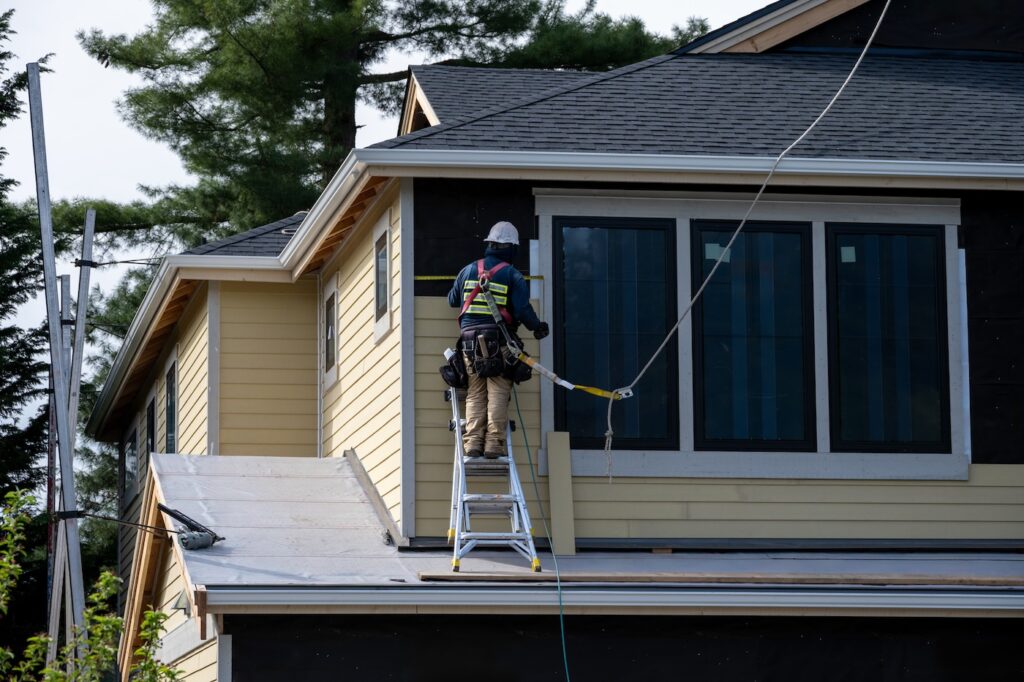 contractor installing siding on delaware home