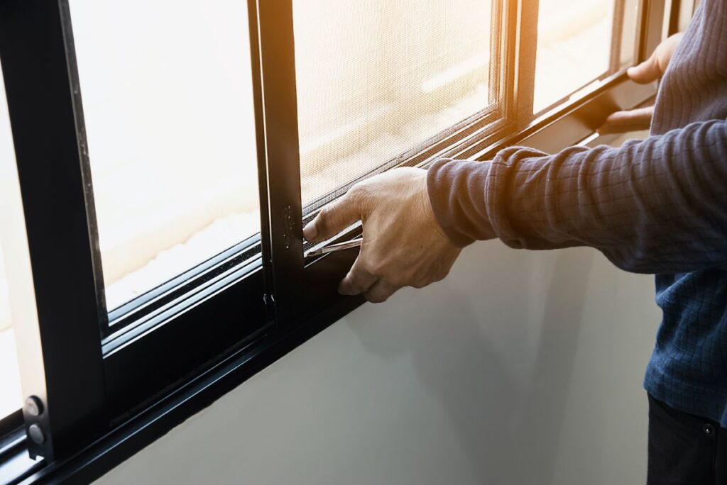 window installation worker installing new black window