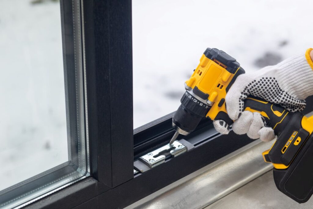 window installation dover de hand holding screwdriver