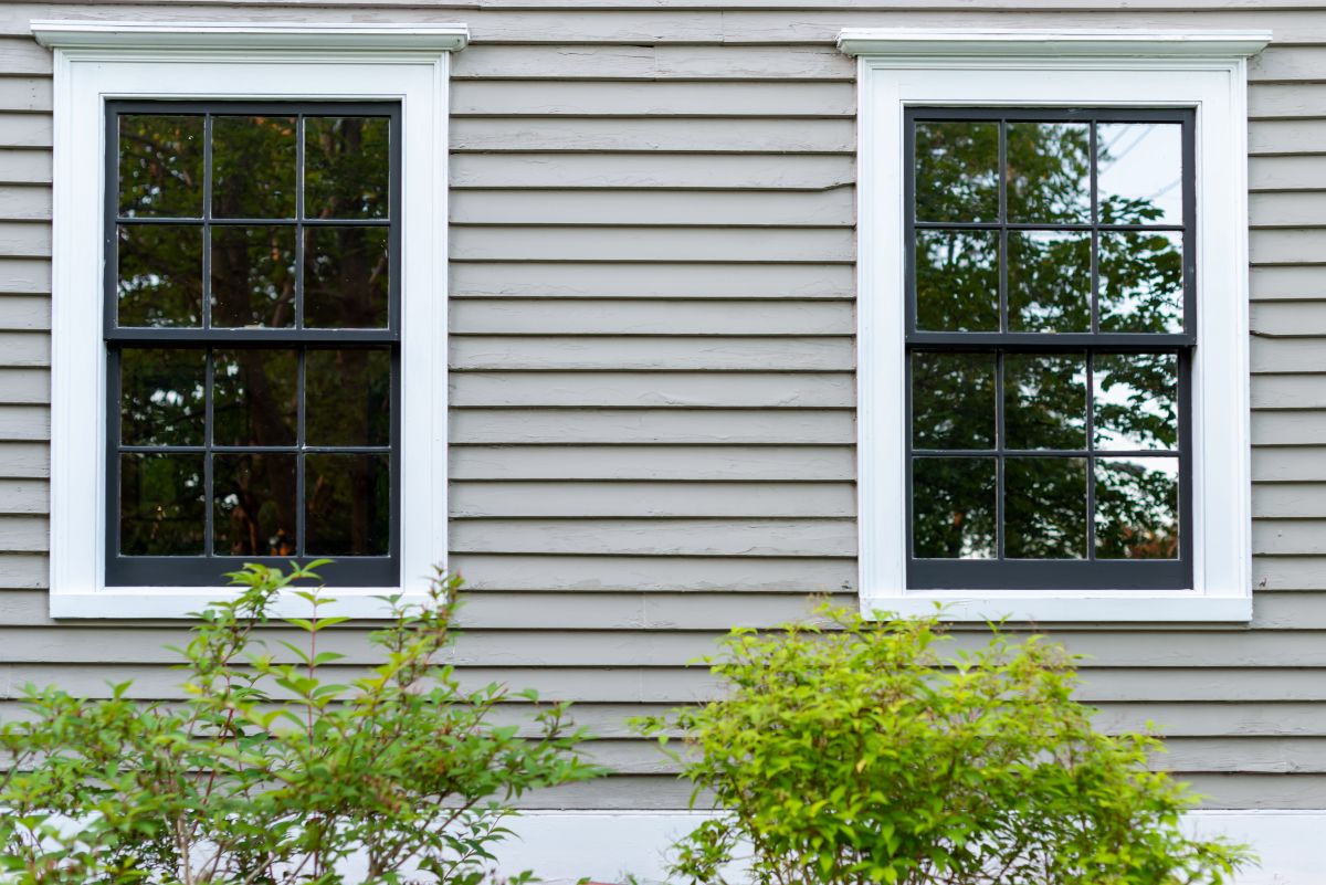 green gray house with white windows