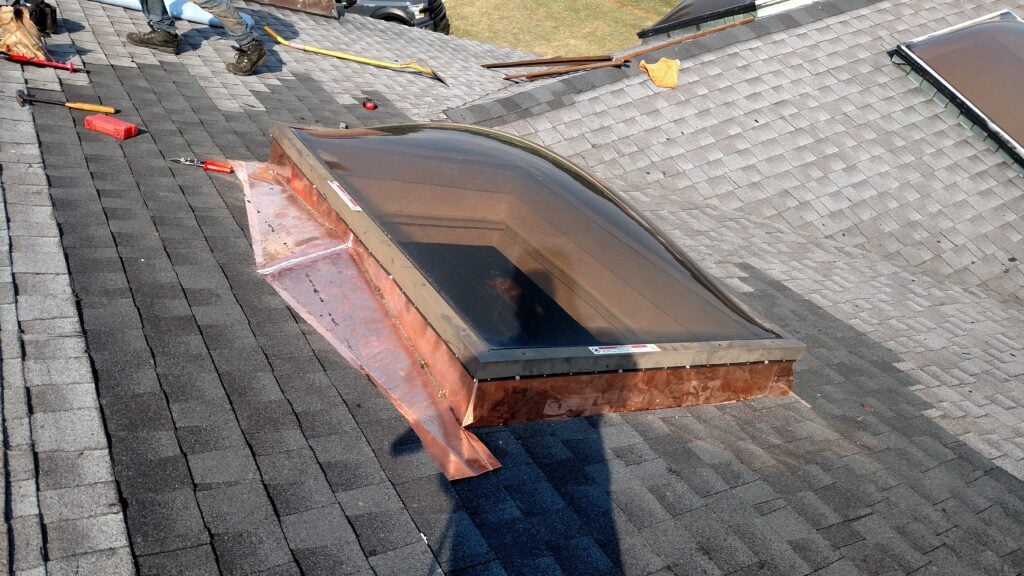 window on top of shingles roof damaged